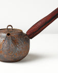 side handle tea pot with wooden handle on white background, front view
