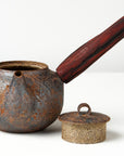 side handle tea pot with wooden handle on white background, front view with lid off