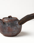 Side handle tea pot with wooden handle on white background. angled view