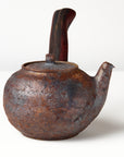 Side handle tea pot with wooden handle on white background. side view