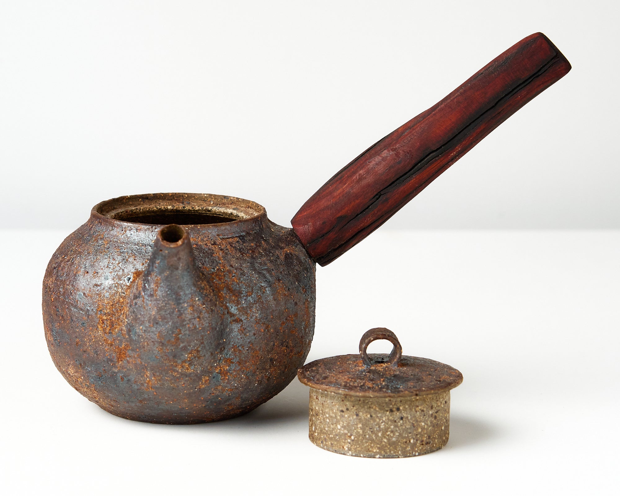 side handle tea pot with wooden handle on white background, front view with lid off