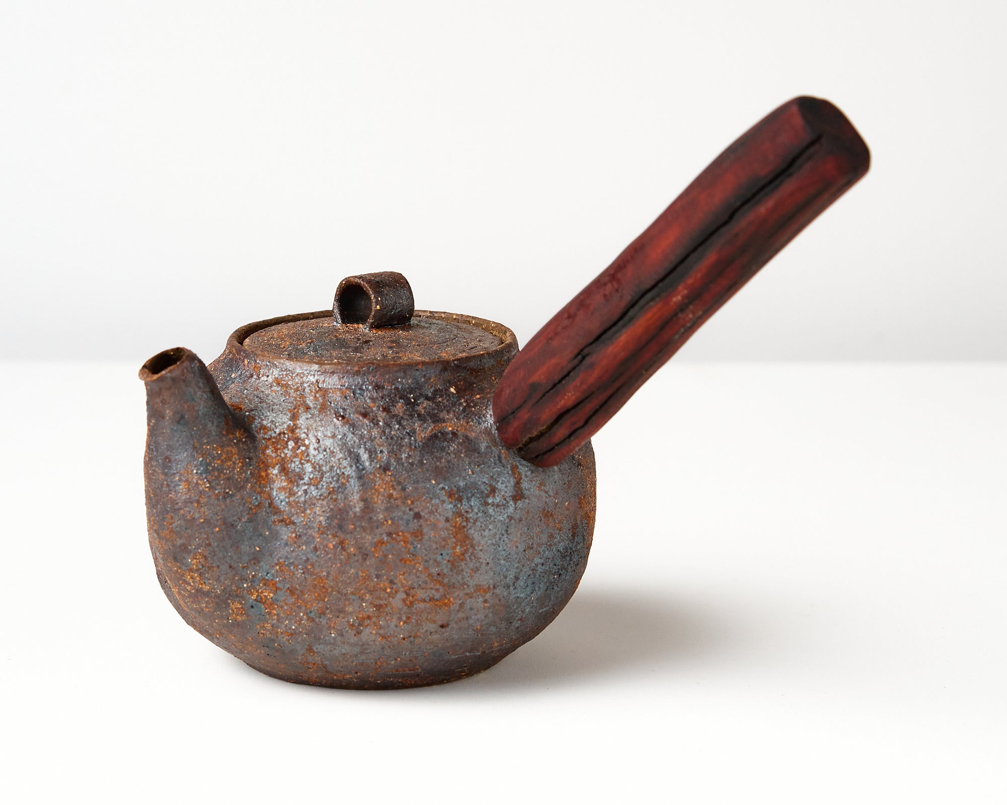 side handle tea pot with wooden handle on white background, angled view