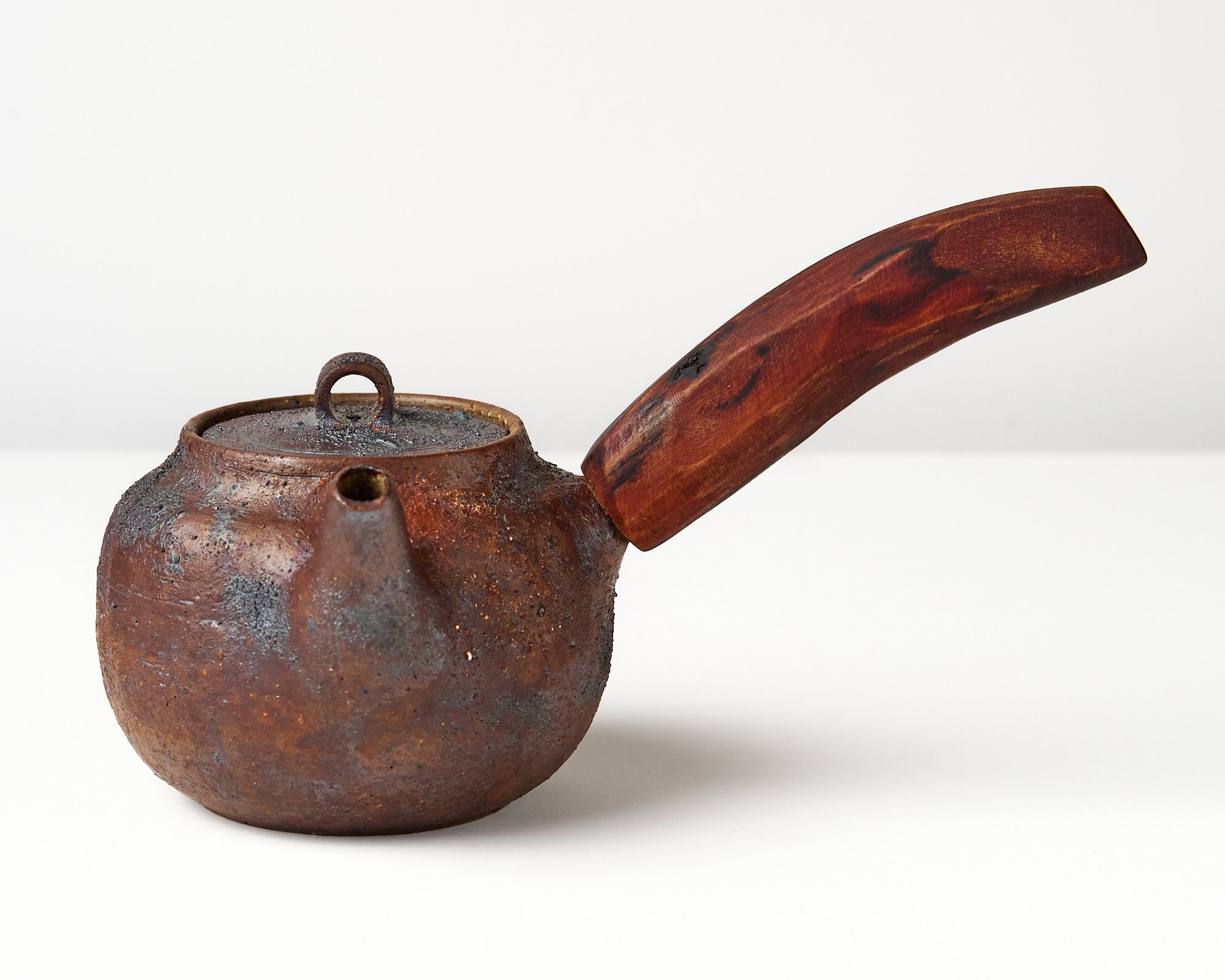 Side handle tea pot with wooden handle on white background. front view 