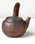 Side handle tea pot with wooden handle on white background. side view 