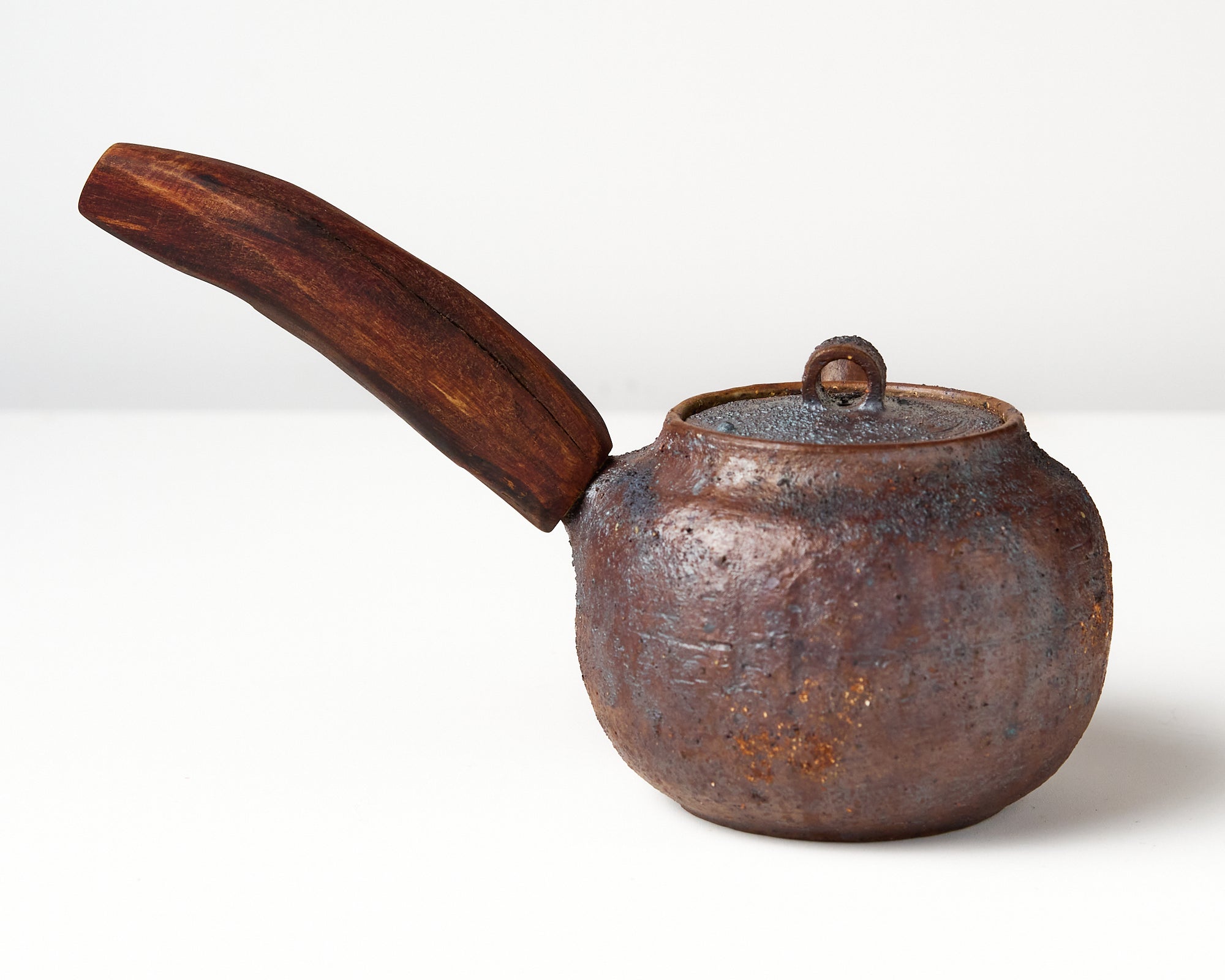 Side handle tea pot with wooden handle on white background. back view 