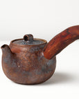 Side handle tea pot with wooden handle on white background. angled view 