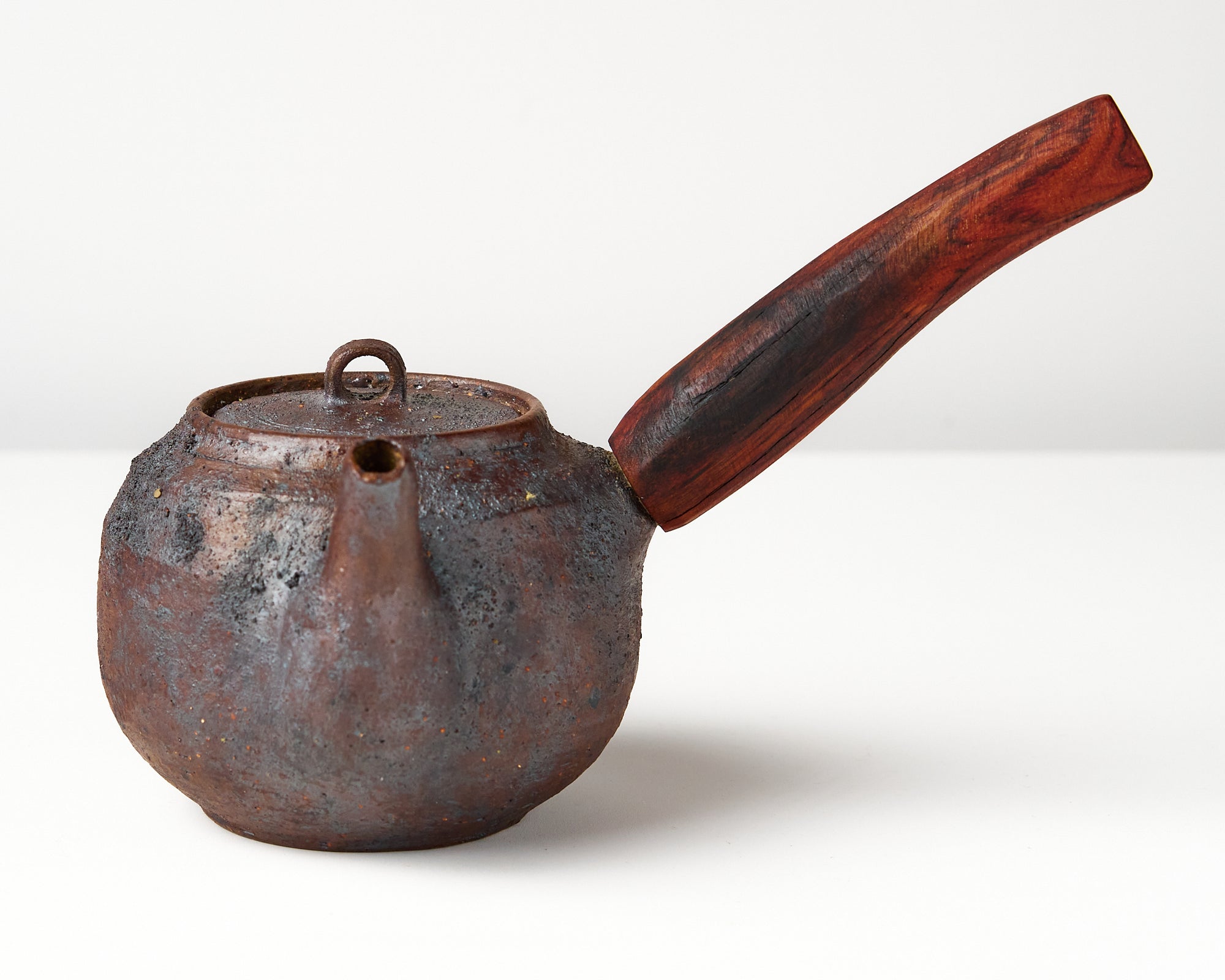 Side handle tea pot with wooden handle on white background. front view 