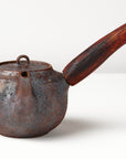 Side handle tea pot with wooden handle on white background. front view 