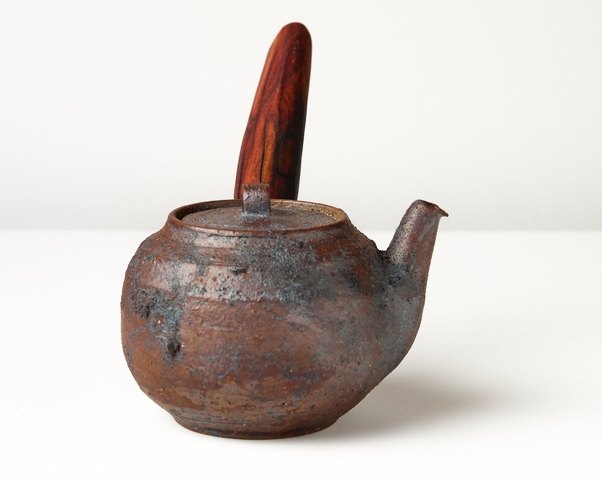 Side handle tea pot with wooden handle on white background. side view 