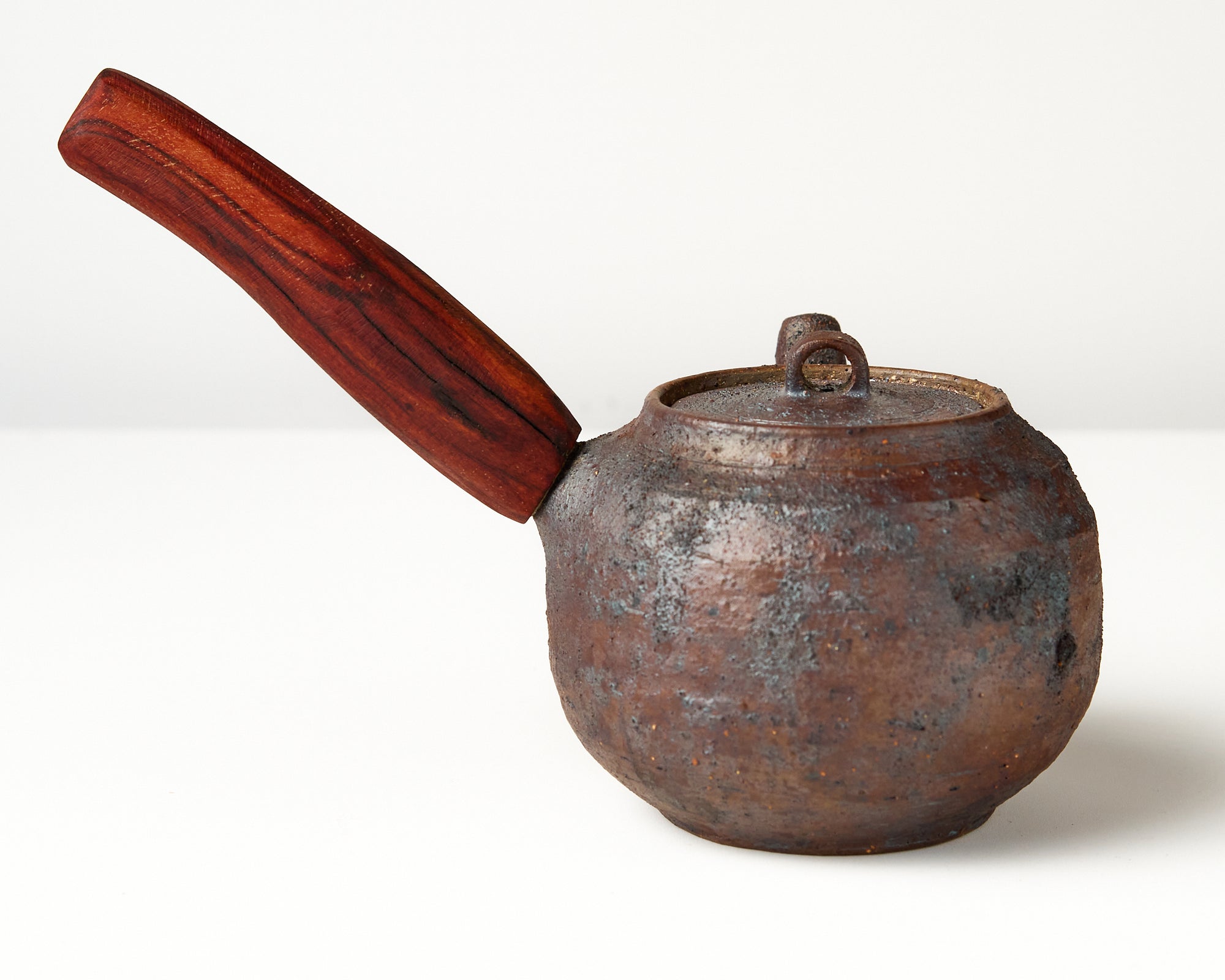 Side handle tea pot with wooden handle on white background. back view 