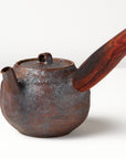 Side handle tea pot with wooden handle on white background. angled view 