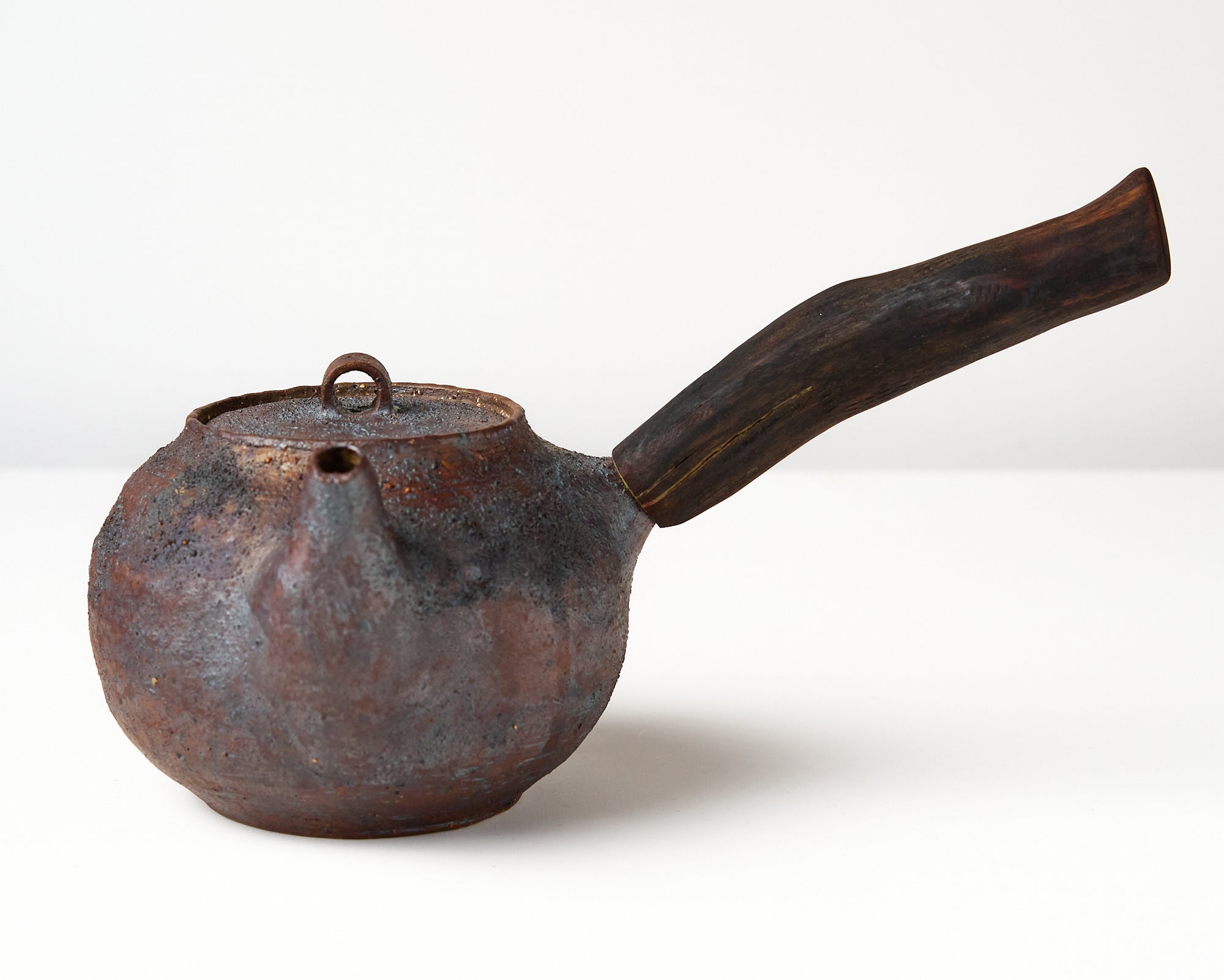 Side handle tea pot with wooden handle on white background. front view 