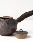 Side handle tea pot with wooden handle on white background. front view with lid off