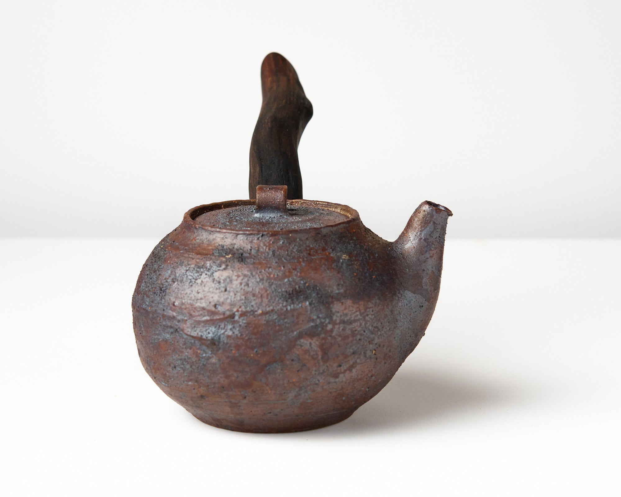 Side handle tea pot with wooden handle on white background. side view 