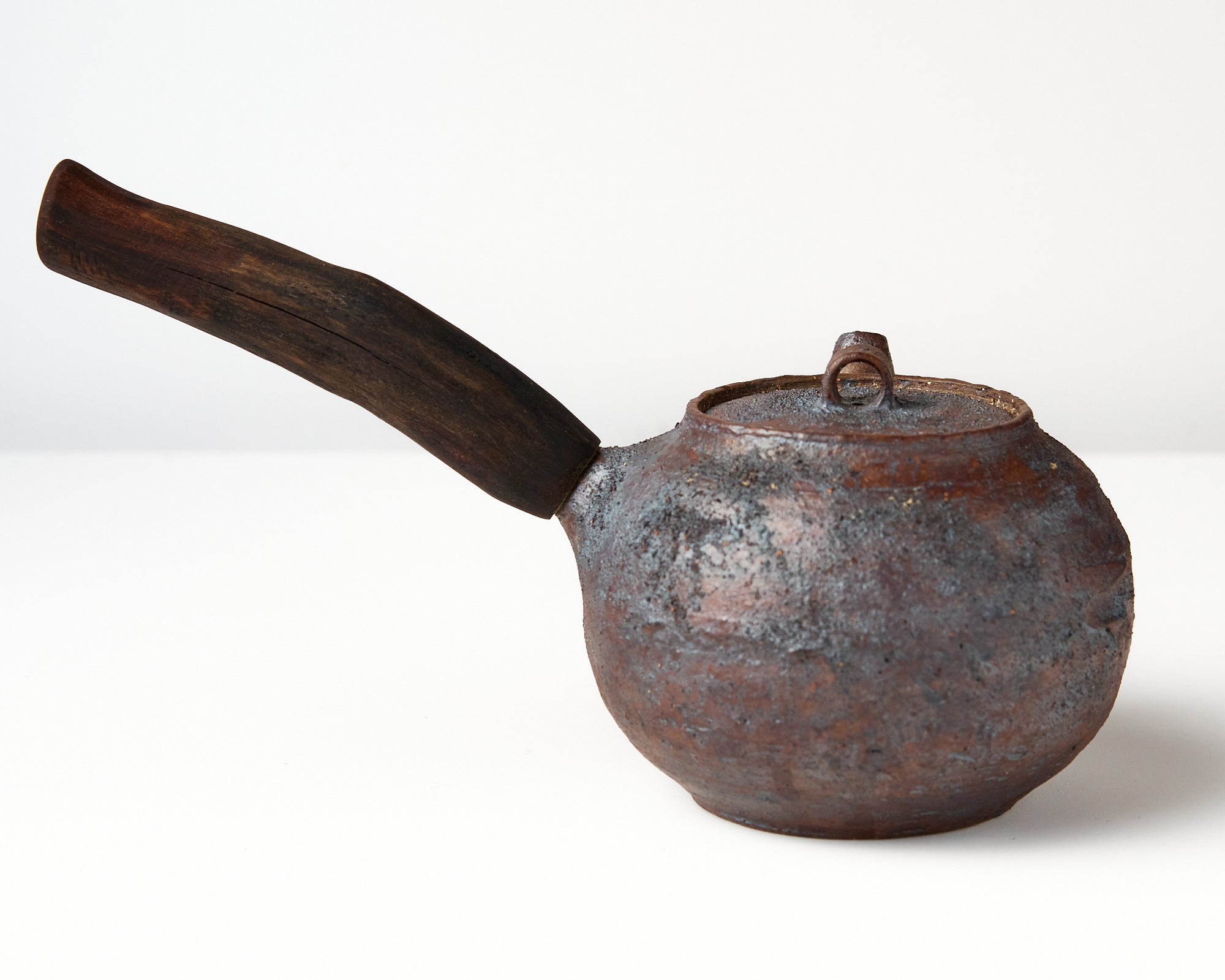 Side handle tea pot with wooden handle on white background. back view 