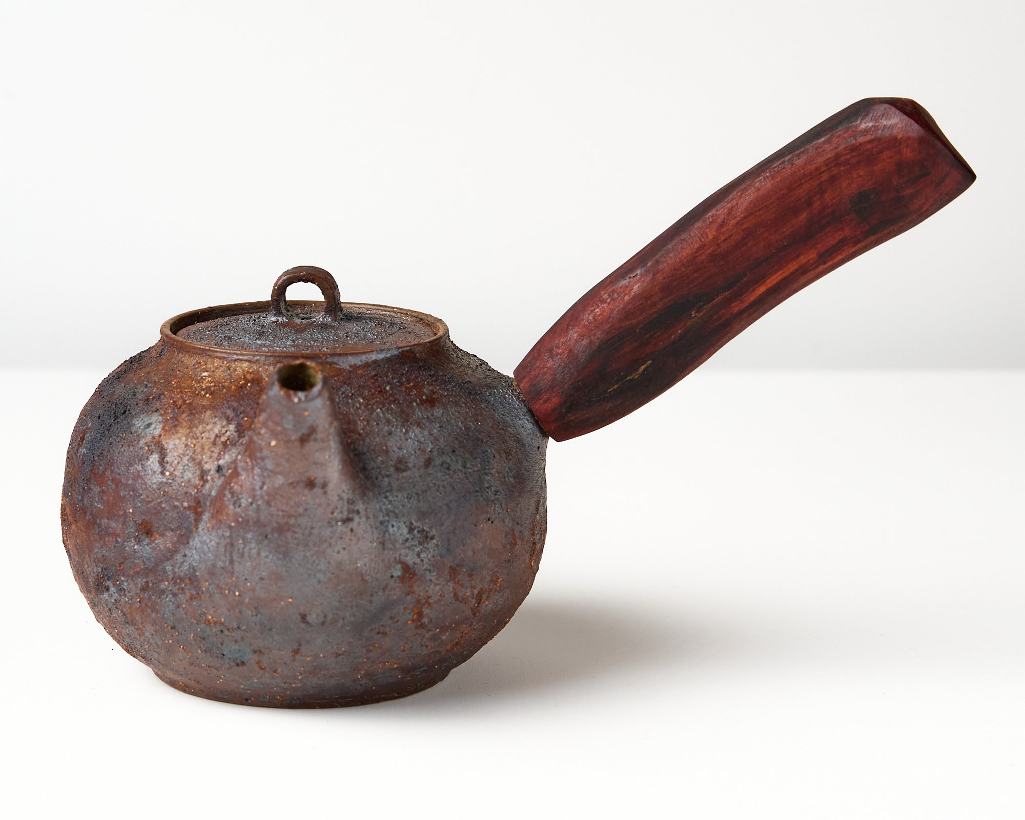 Side handle tea pot with wooden handle on white background. front view