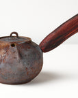 Side handle tea pot with wooden handle on white background. front view