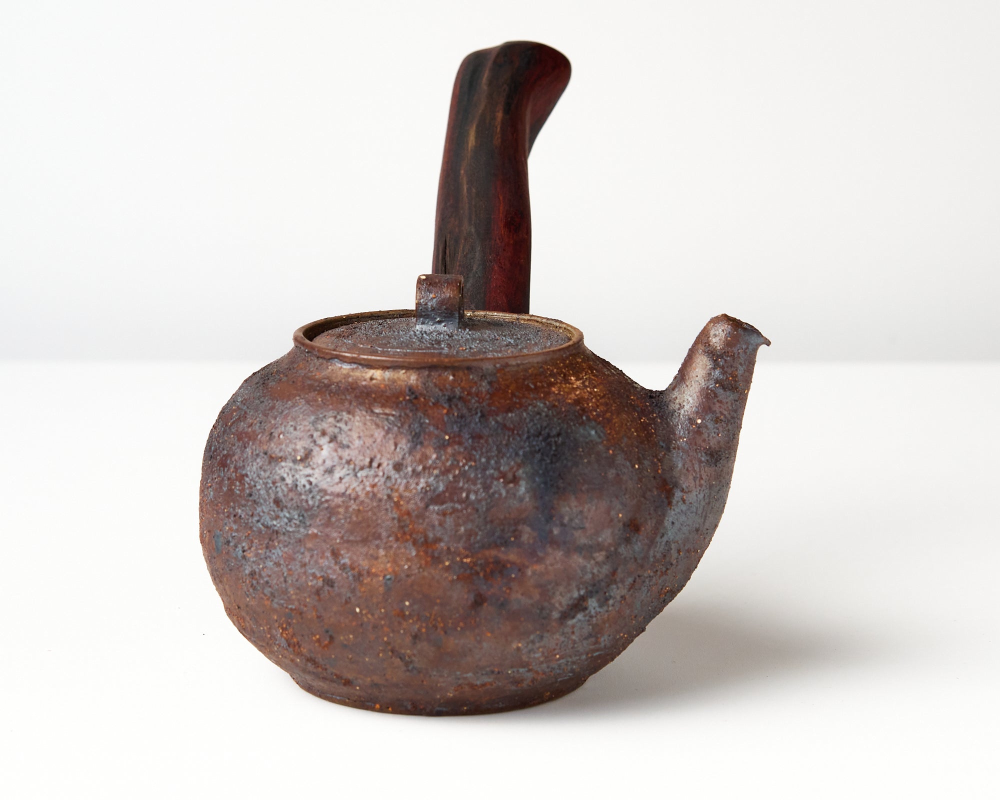Side handle tea pot with wooden handle on white background. side view 