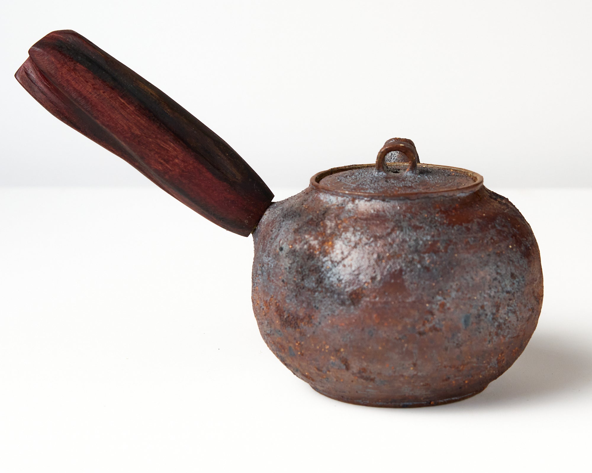 Side handle tea pot with wooden handle on white background. back view 