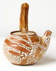 Ceramic teapot with wooden handle on a white background, side view